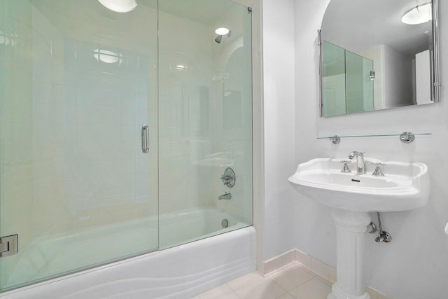 bathroom with tile patterned floors and combined bath / shower with glass door