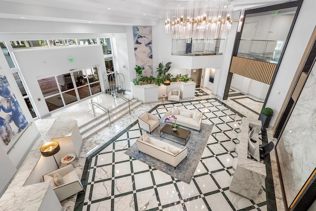 living room featuring an inviting chandelier and ornamental molding