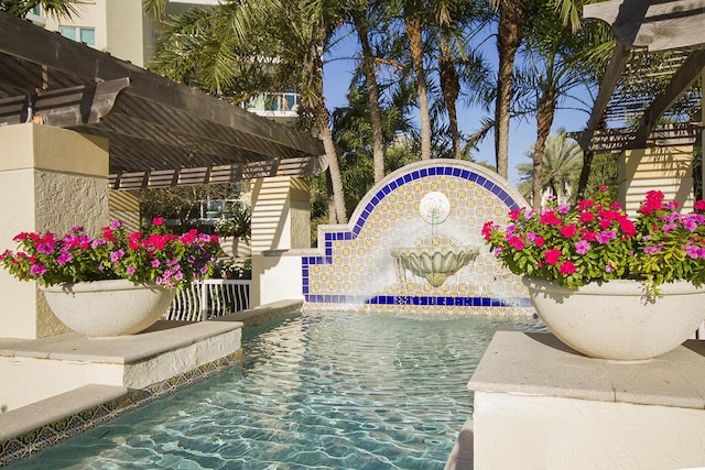 view of swimming pool featuring a pergola and pool water feature