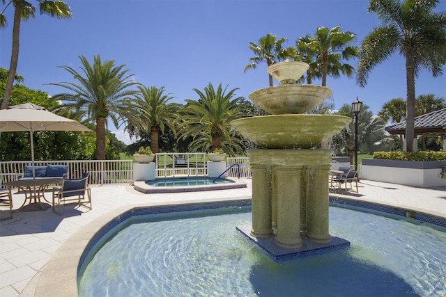 view of swimming pool with an in ground hot tub and a patio