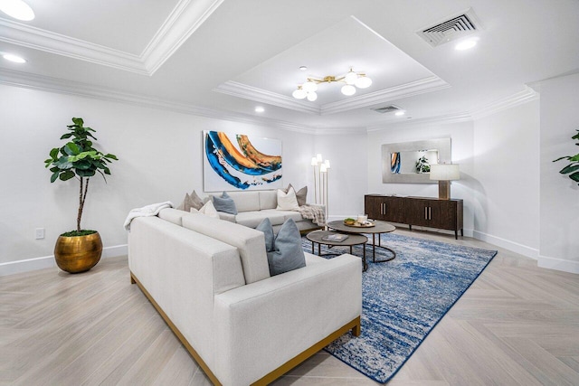 living room featuring a raised ceiling, ornamental molding, and light parquet floors