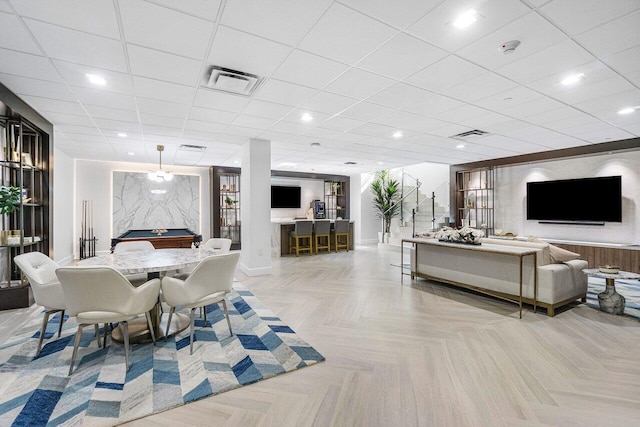 dining area with light parquet floors and a paneled ceiling