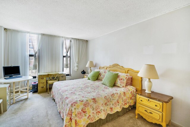 bedroom featuring carpet and a textured ceiling