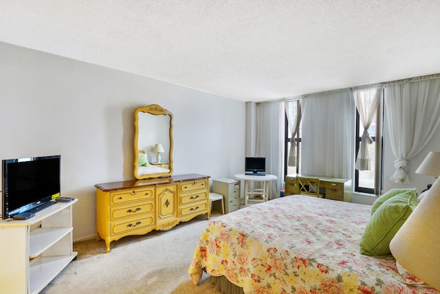 carpeted bedroom featuring multiple windows and a textured ceiling