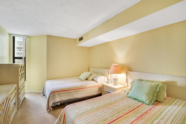 carpeted bedroom with a textured ceiling