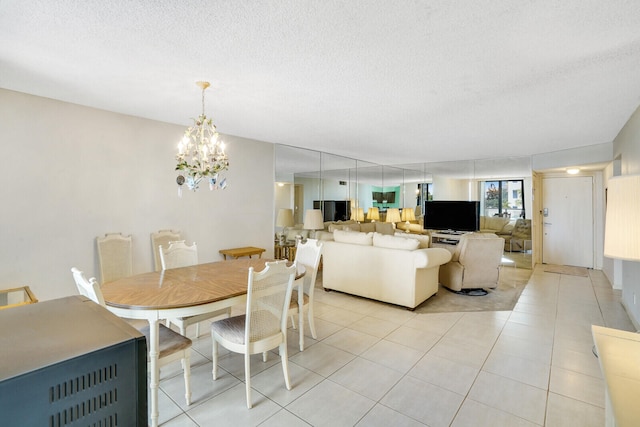 dining room with a textured ceiling, an inviting chandelier, and light tile patterned floors