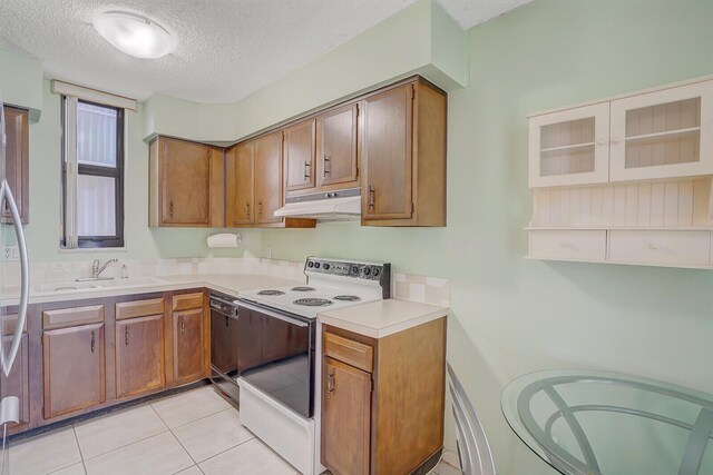 kitchen featuring a textured ceiling, black dishwasher, light tile patterned floors, sink, and white electric range oven