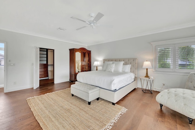 bedroom featuring ceiling fan, crown molding, and wood-type flooring