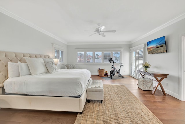 bedroom with ceiling fan, hardwood / wood-style flooring, and crown molding