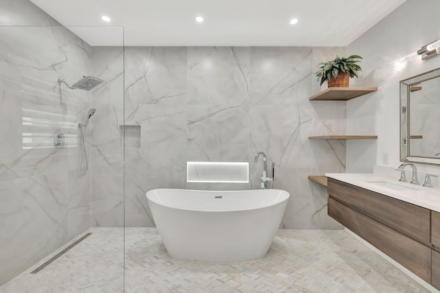 bathroom featuring shower with separate bathtub, vanity, and tile walls