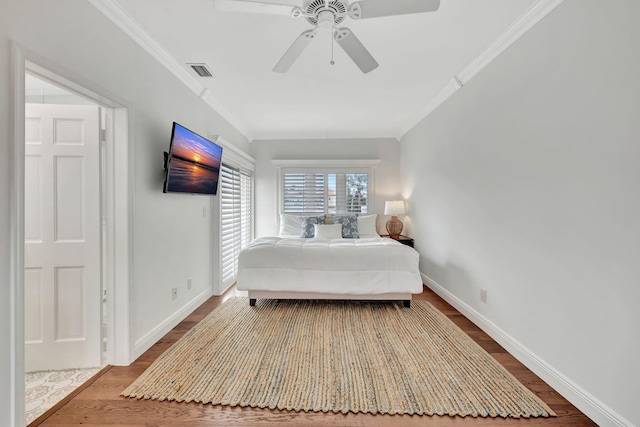 bedroom with ornamental molding, hardwood / wood-style floors, and ceiling fan