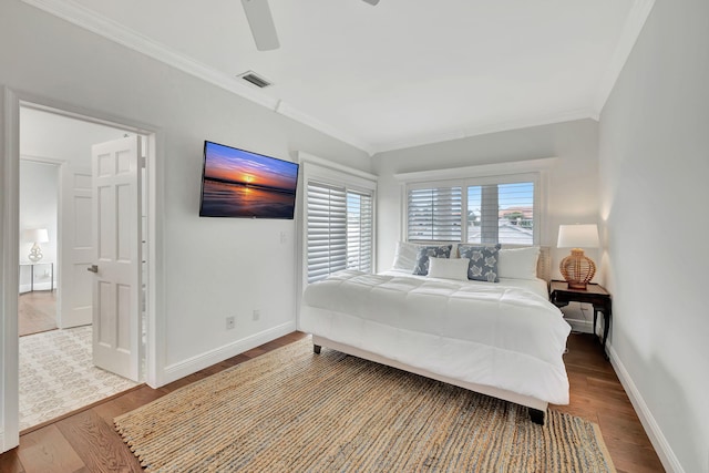 bedroom with ornamental molding, ceiling fan, and hardwood / wood-style flooring