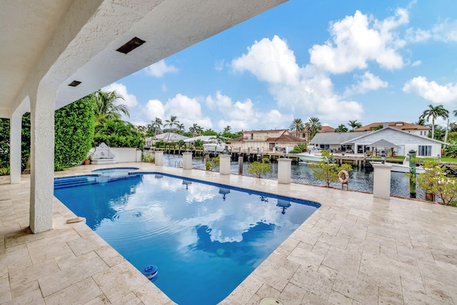 view of pool featuring a water view and a patio area