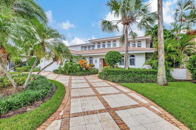 mediterranean / spanish house featuring a front yard