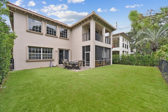 rear view of property with a yard and a patio