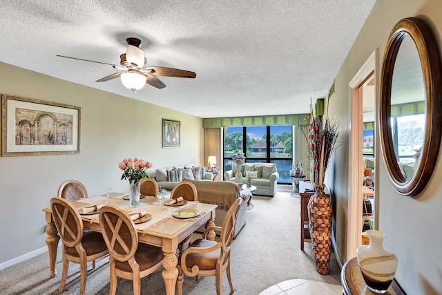 carpeted dining space featuring a textured ceiling and ceiling fan