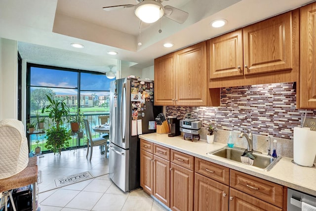 kitchen with ceiling fan, sink, backsplash, light tile patterned floors, and appliances with stainless steel finishes