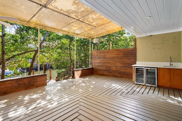 deck with wine cooler and a sink