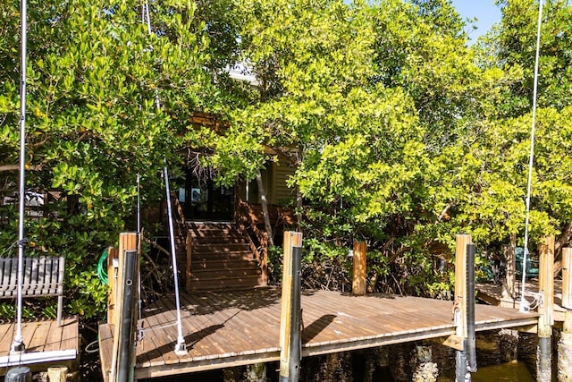 view of dock featuring stairs and a deck