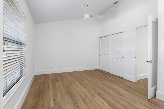 unfurnished bedroom with light wood-style flooring, baseboards, and a closet