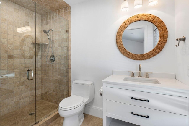 bathroom with baseboards, a shower stall, toilet, and vanity