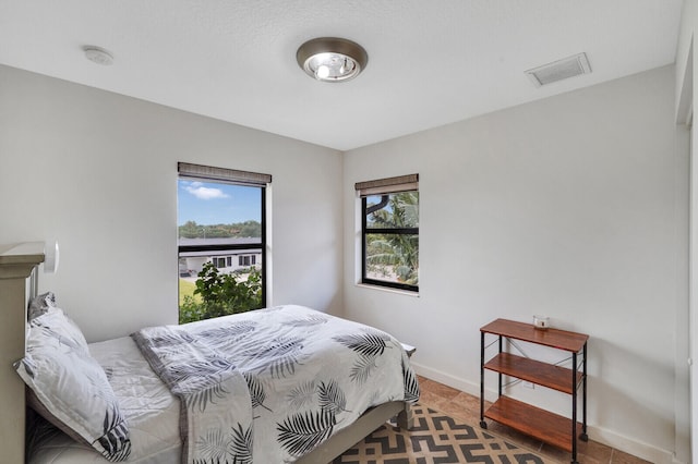 bedroom featuring tile patterned flooring