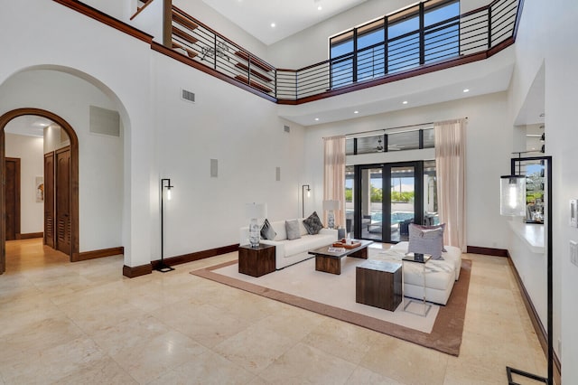 interior space with french doors and a towering ceiling