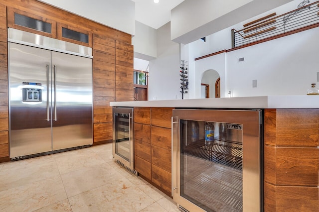 kitchen featuring stainless steel built in fridge and beverage cooler