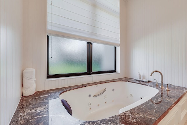 bathroom with wood walls and a relaxing tiled tub