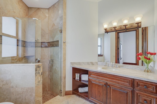 bathroom with tile patterned flooring, a shower with shower door, and vanity