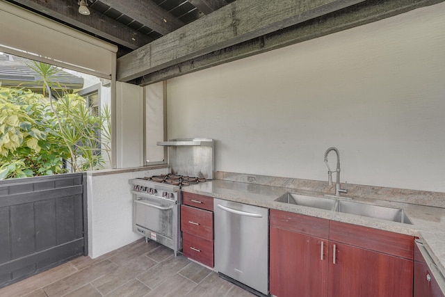 kitchen featuring stainless steel appliances, sink, beam ceiling, and light hardwood / wood-style floors