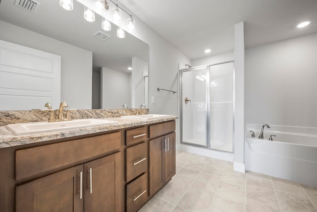 bathroom with tile patterned floors, vanity, and independent shower and bath