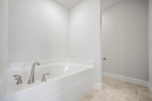 bathroom featuring tile patterned flooring and a tub to relax in