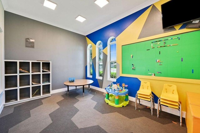 playroom featuring carpet floors and lofted ceiling