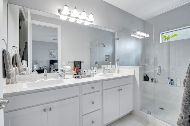 bathroom with tile patterned flooring, walk in shower, and vanity