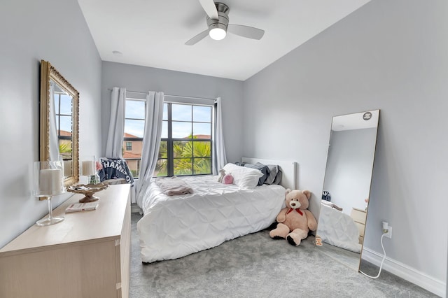 carpeted bedroom featuring ceiling fan and multiple windows