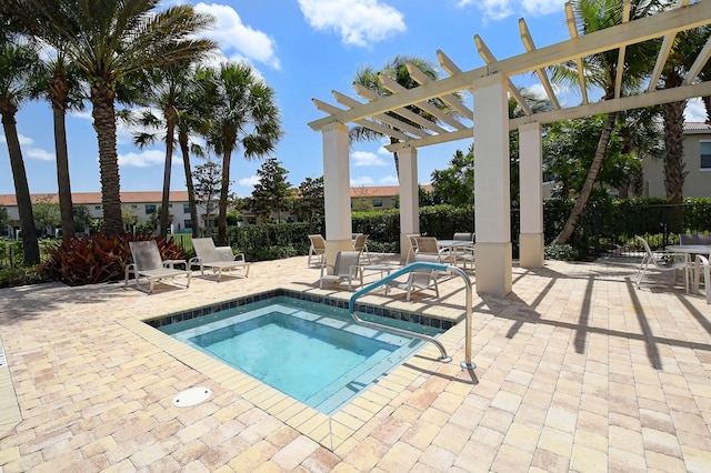 view of pool featuring a hot tub, a pergola, and a patio area