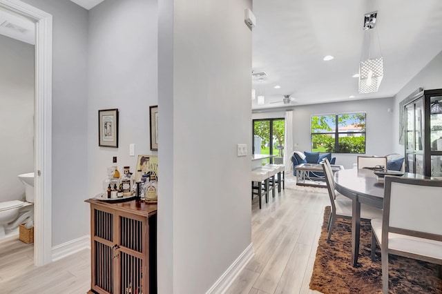 interior space featuring light hardwood / wood-style flooring and a chandelier