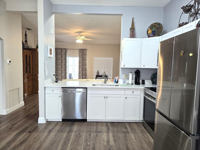 kitchen featuring ceiling fan, stainless steel appliances, dark hardwood / wood-style floors, and white cabinetry