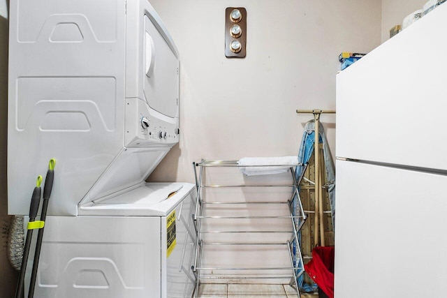 laundry room featuring stacked washer / drying machine