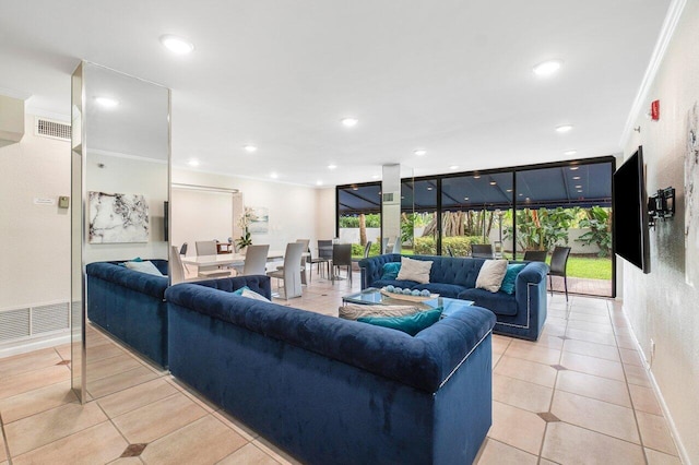 living room with light tile patterned flooring, ornamental molding, and expansive windows