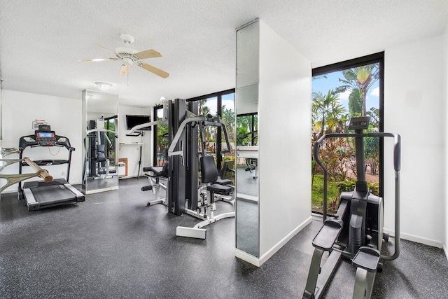 gym featuring floor to ceiling windows, a textured ceiling, and ceiling fan