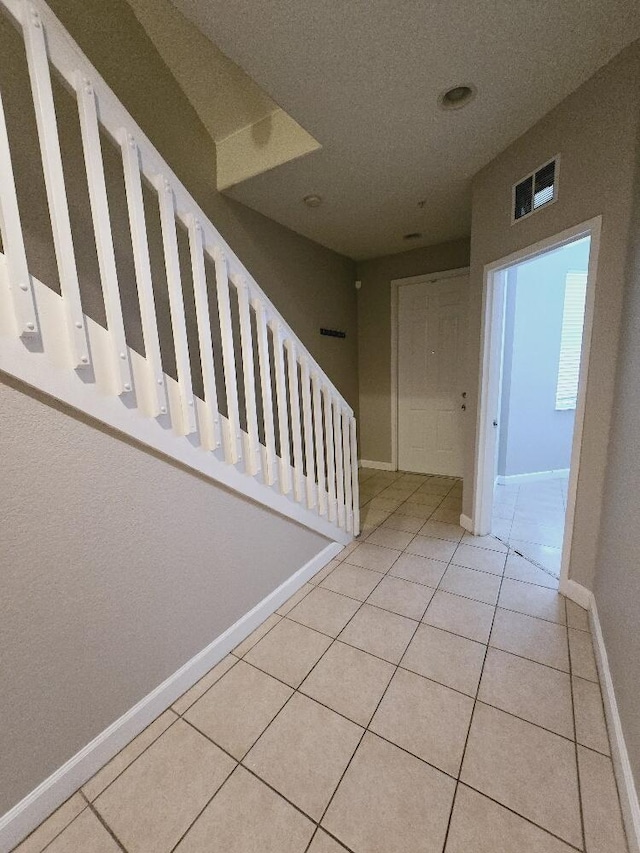 staircase with tile patterned floors