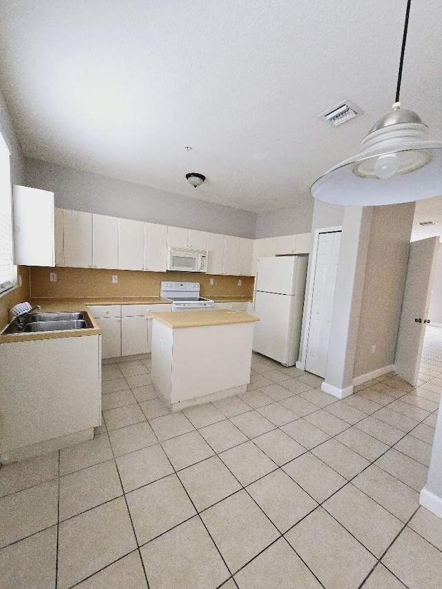 kitchen featuring white cabinetry, sink, a kitchen island, white appliances, and hanging light fixtures