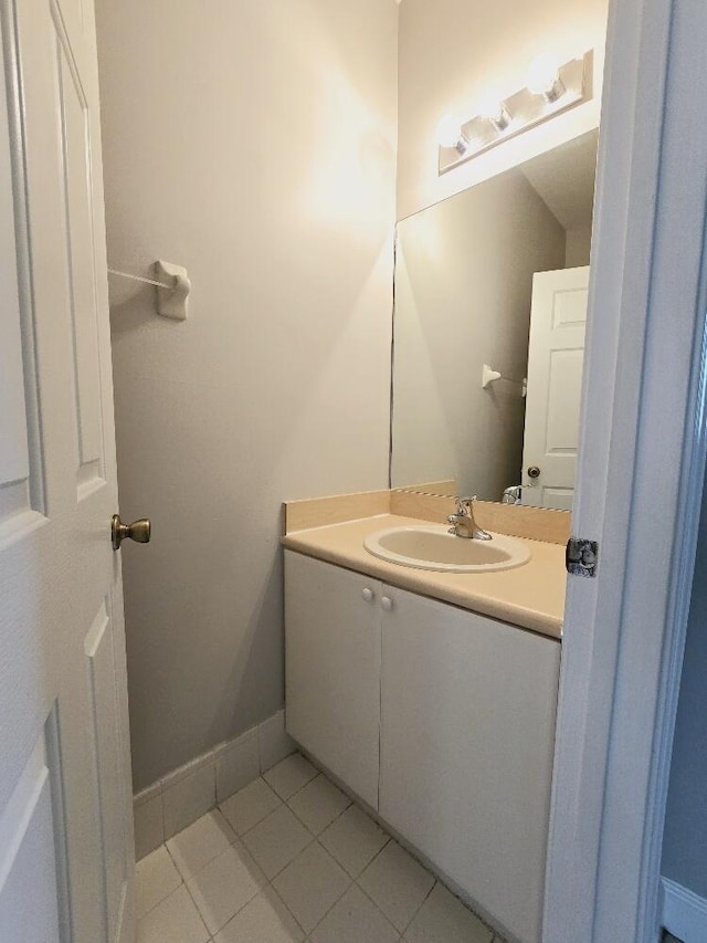 bathroom featuring vanity, baseboards, and tile patterned floors