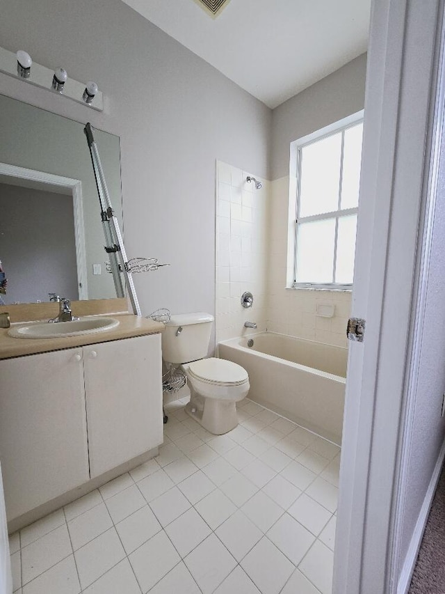 full bathroom featuring tiled shower / bath combo, tile patterned floors, toilet, and vanity