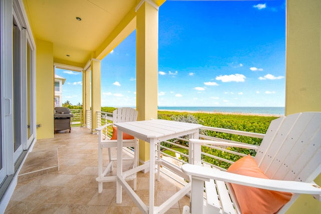 balcony with grilling area and a water view