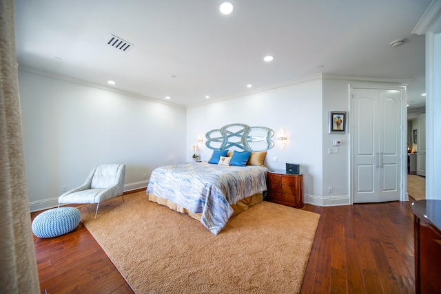 bedroom with dark hardwood / wood-style flooring and crown molding