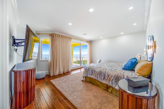 bedroom with access to exterior, crown molding, and dark hardwood / wood-style flooring