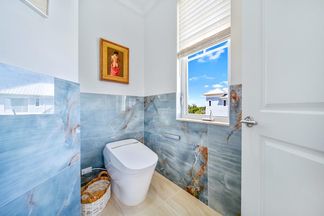 bathroom featuring tile patterned floors, tile walls, and crown molding